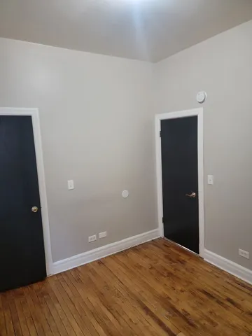 an empty room with wooden floor