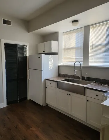 a kitchen with refrigerator and window