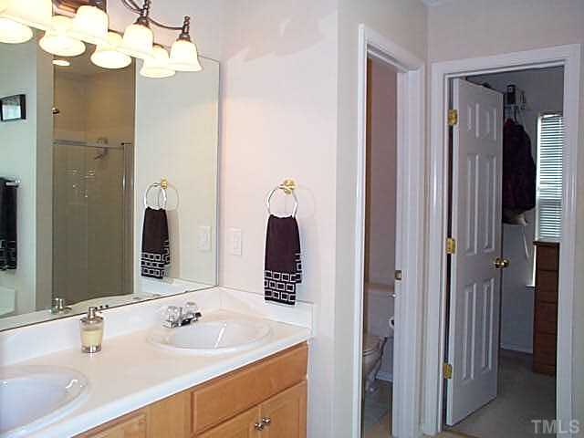 5331 Seaspray Lane Raleigh, NC 27610 - Photo 8 of 12 Master bathroom with double sinks, soaking tub and separate stall shower