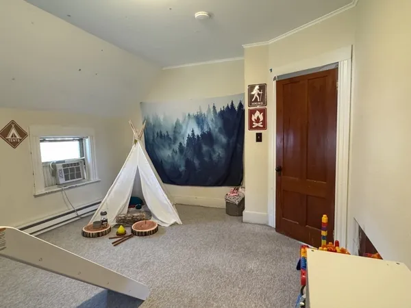 a view of a livingroom with furniture and toys