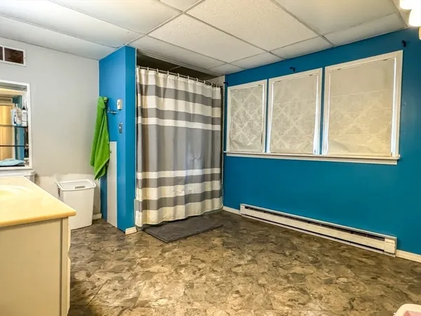 a spacious bathroom with a double vanity sink a mirror a bathtub and a shower