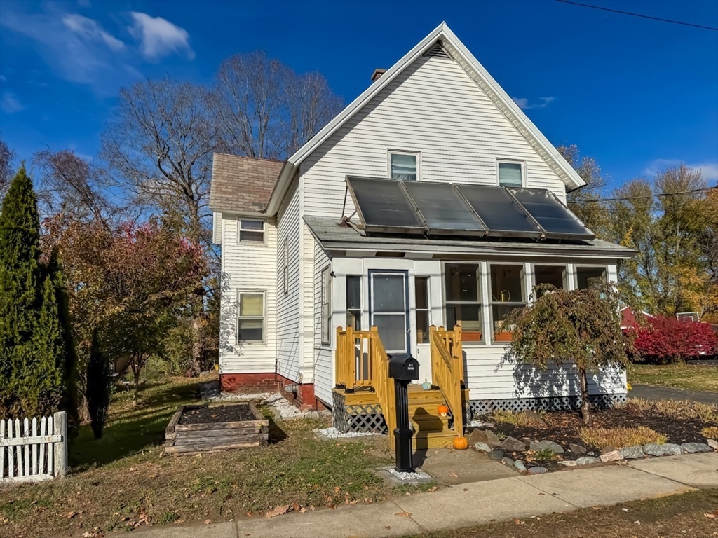83 Newton Street Greenfield, MA 01301 - Photo 34 of 42 a view of a white house with a yard and potted plants