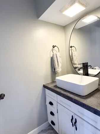 a bathroom with a sink and a mirror