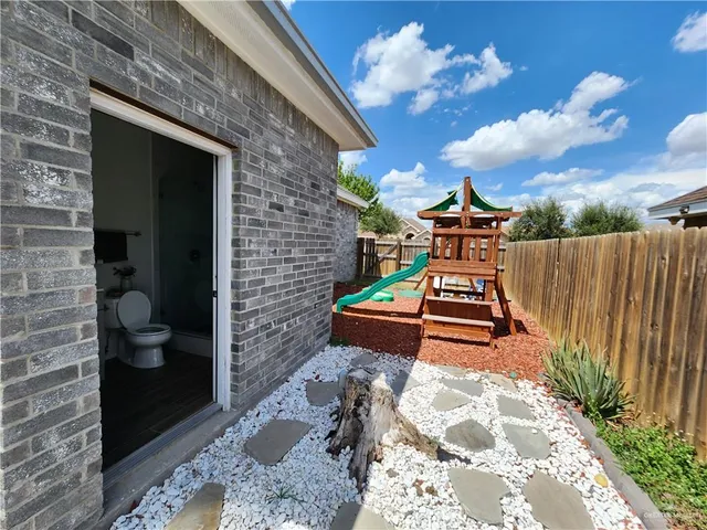 a bench sitting in front of a brick house