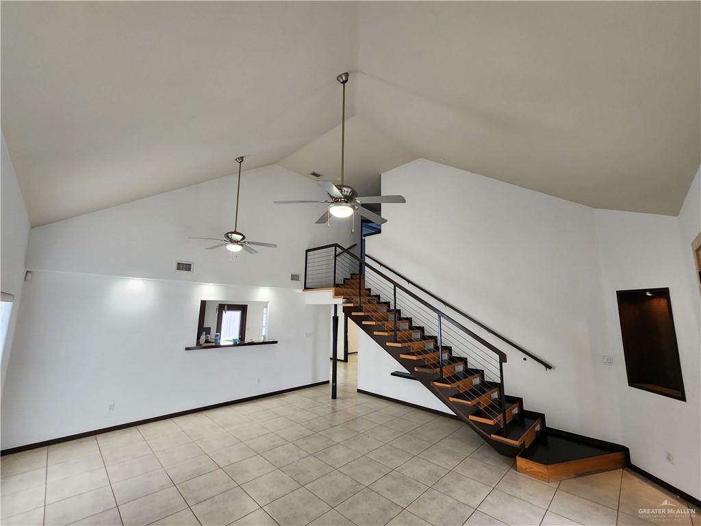2821 Grayson Avenue McAllen, TX 78504 - Photo 19 of 31 a view of a hallway with stairs and a chandelier