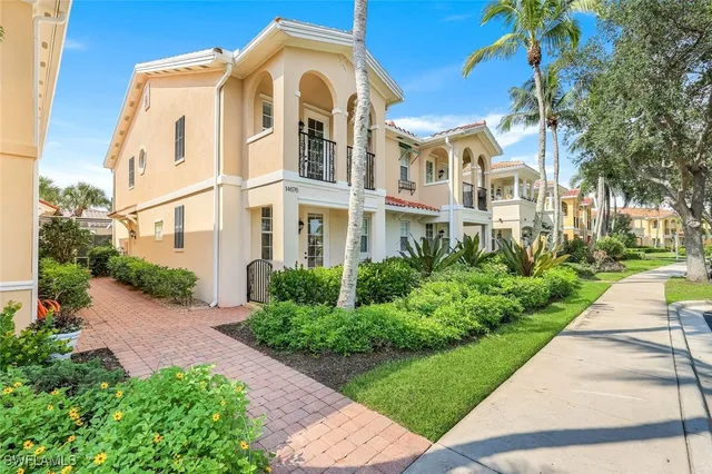 a view of a brick house with a yard