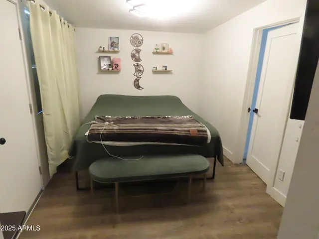 a bedroom with a bed and a window