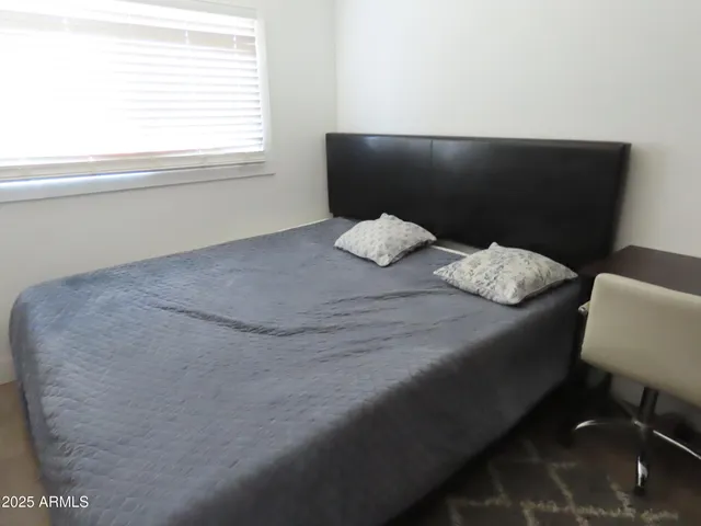 a bed sitting in a bedroom next to a window
