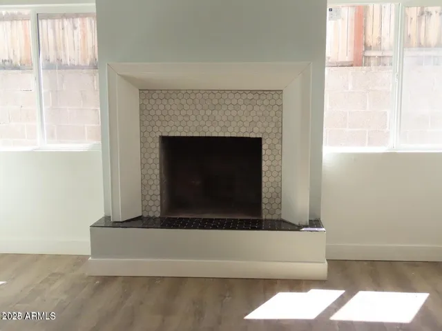 a living room with a fireplace and a floor to ceiling window