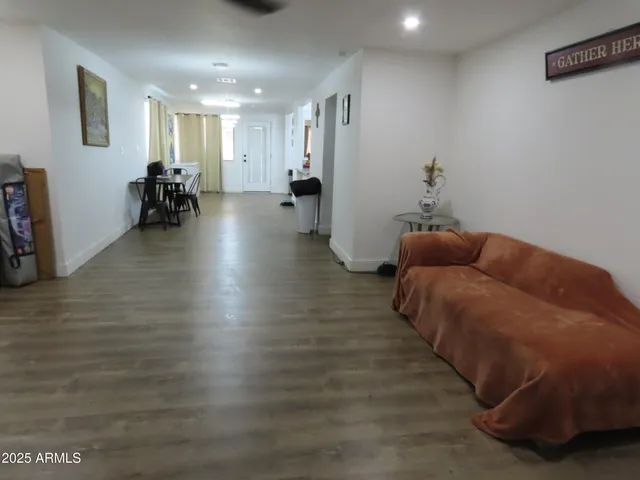 a living room with furniture and a wooden floor