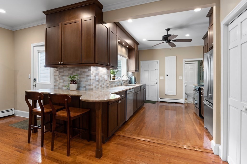 8 Sheafe Street, Unit 1 Boston, MA 02129 - Photo 4 of 19 a kitchen with stainless steel appliances granite countertop a sink a stove and a refrigerator