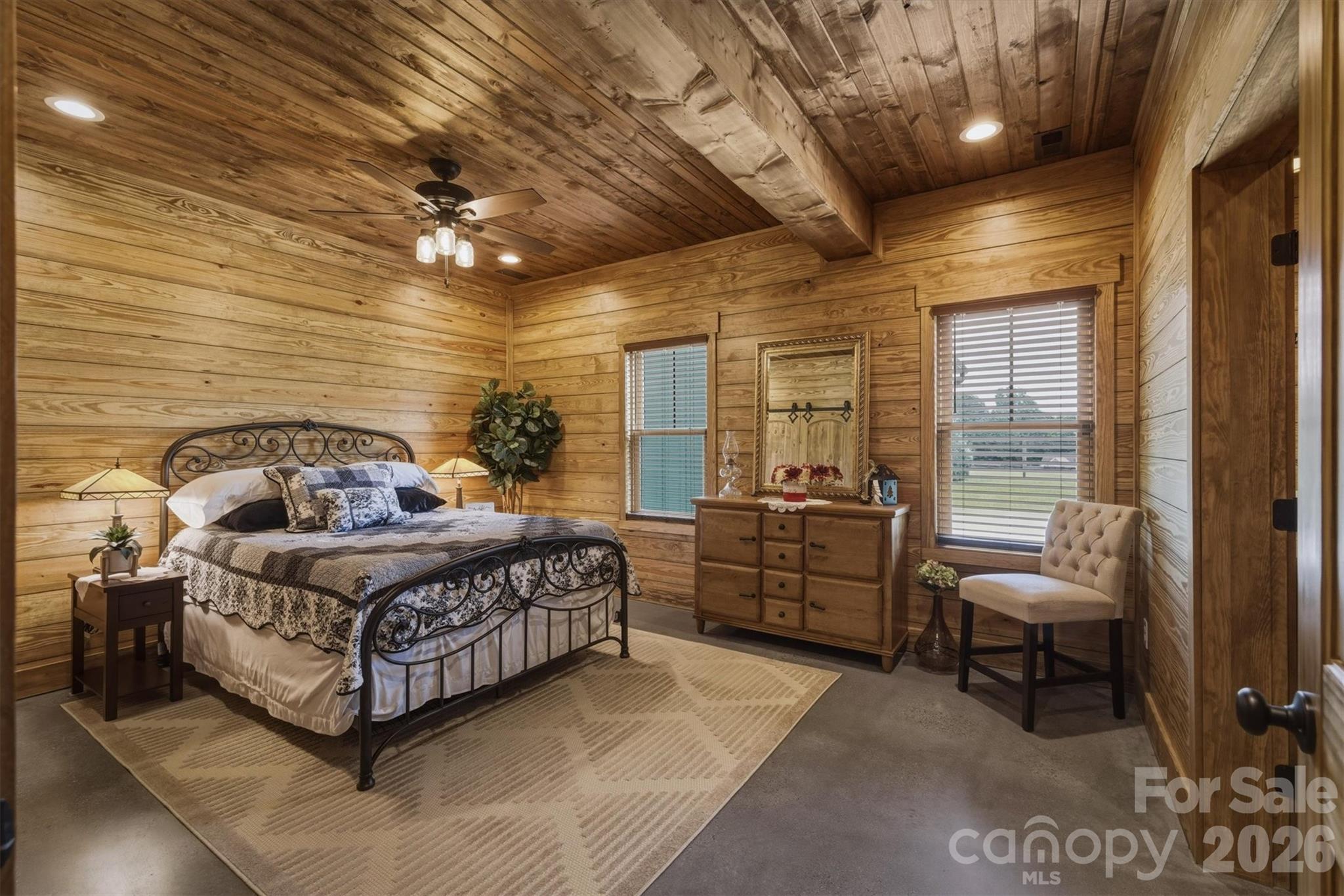 7490 Oak Ridge Church Road Connelly Springs, NC 28612 - Photo 20 of 44 a spacious bedroom with a bed and a chandelier