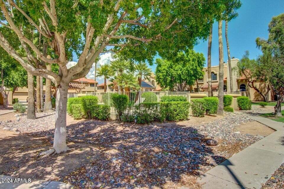 5640 East Bell Road, Unit 1022 Scottsdale, AZ 85254 - Photo 19 of 27 a view of a house with a tree in the background
