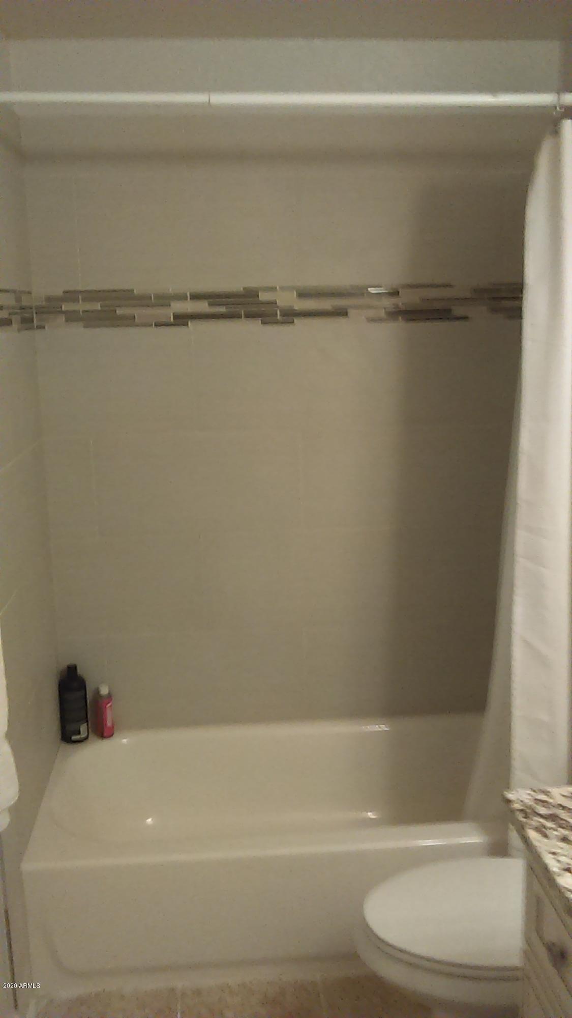 5640 East Bell Road, Unit 1022 Scottsdale, AZ 85254 - Photo 7 of 27 a bathroom with a shower and a bathtub