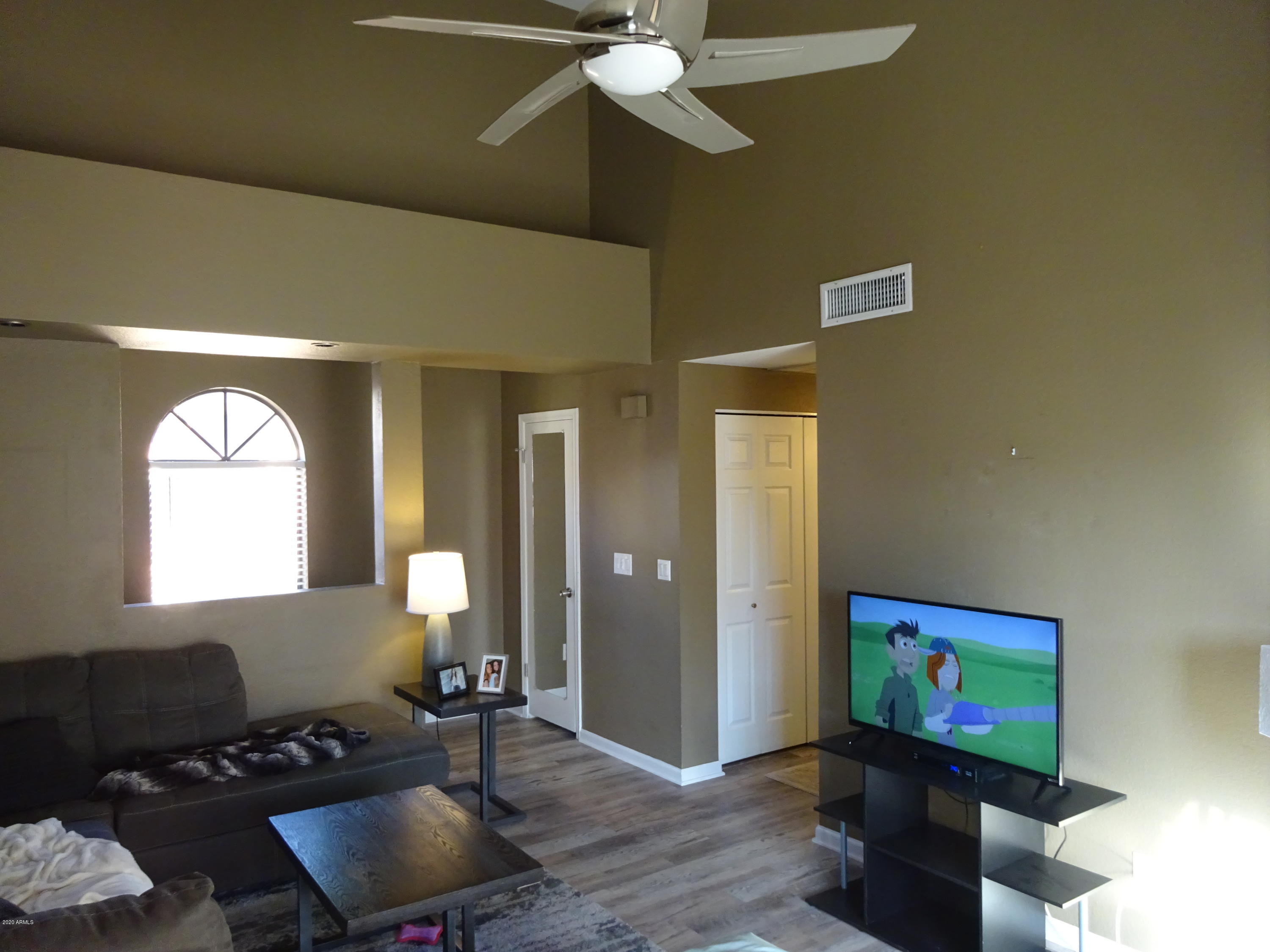 5640 East Bell Road, Unit 1022 Scottsdale, AZ 85254 - Photo 9 of 27 a living room with furniture and a flat screen tv
