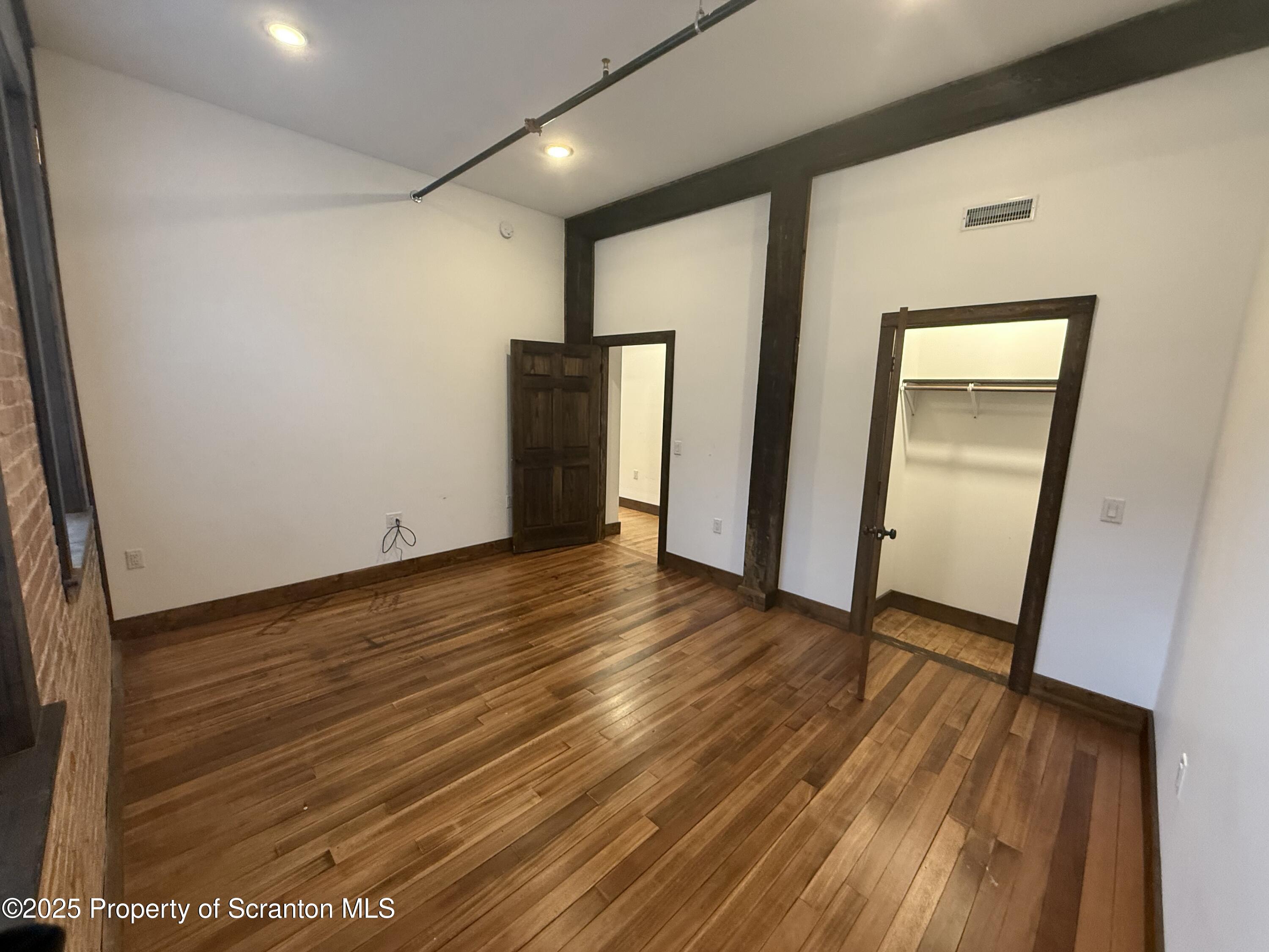 103 Park Street, Unit 1A Honesdale, PA 18431 - Photo 12 of 15 a view of an empty room with wooden floor