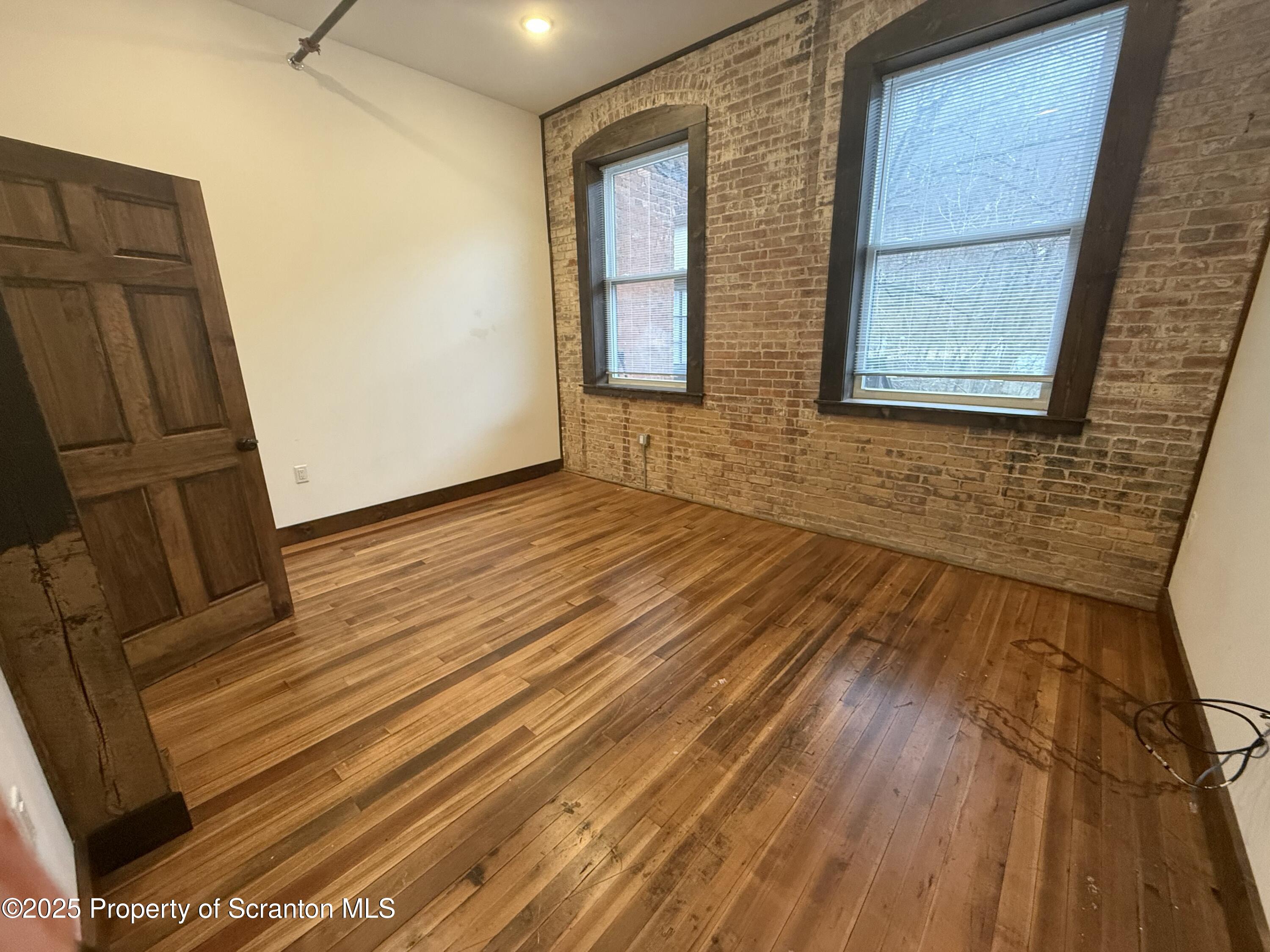 103 Park Street, Unit 1A Honesdale, PA 18431 - Photo 13 of 15 a view of an empty room with wooden floor and a window