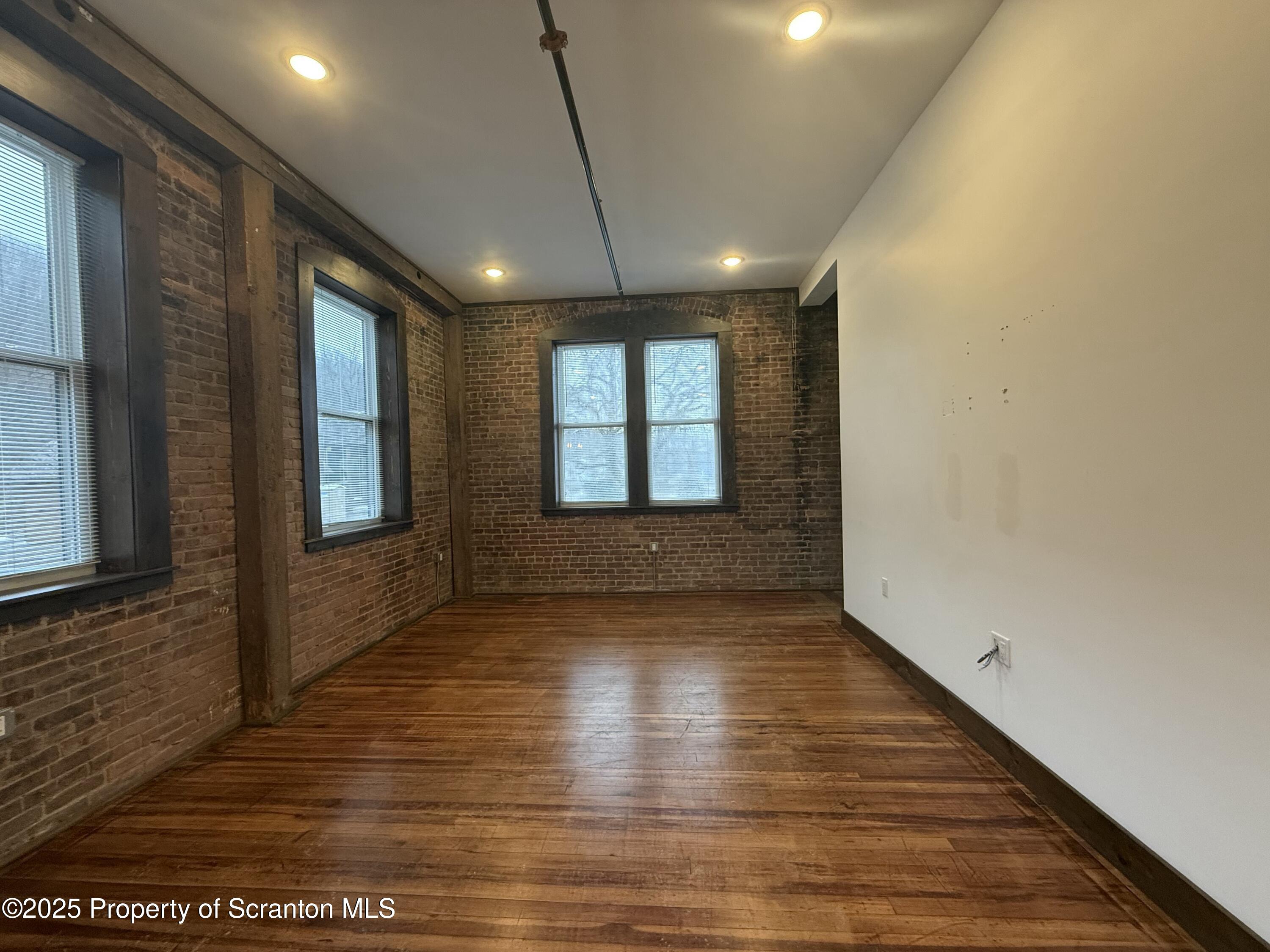 103 Park Street, Unit 1A Honesdale, PA 18431 - Photo 4 of 15 a view of an empty room with wooden floor and a window