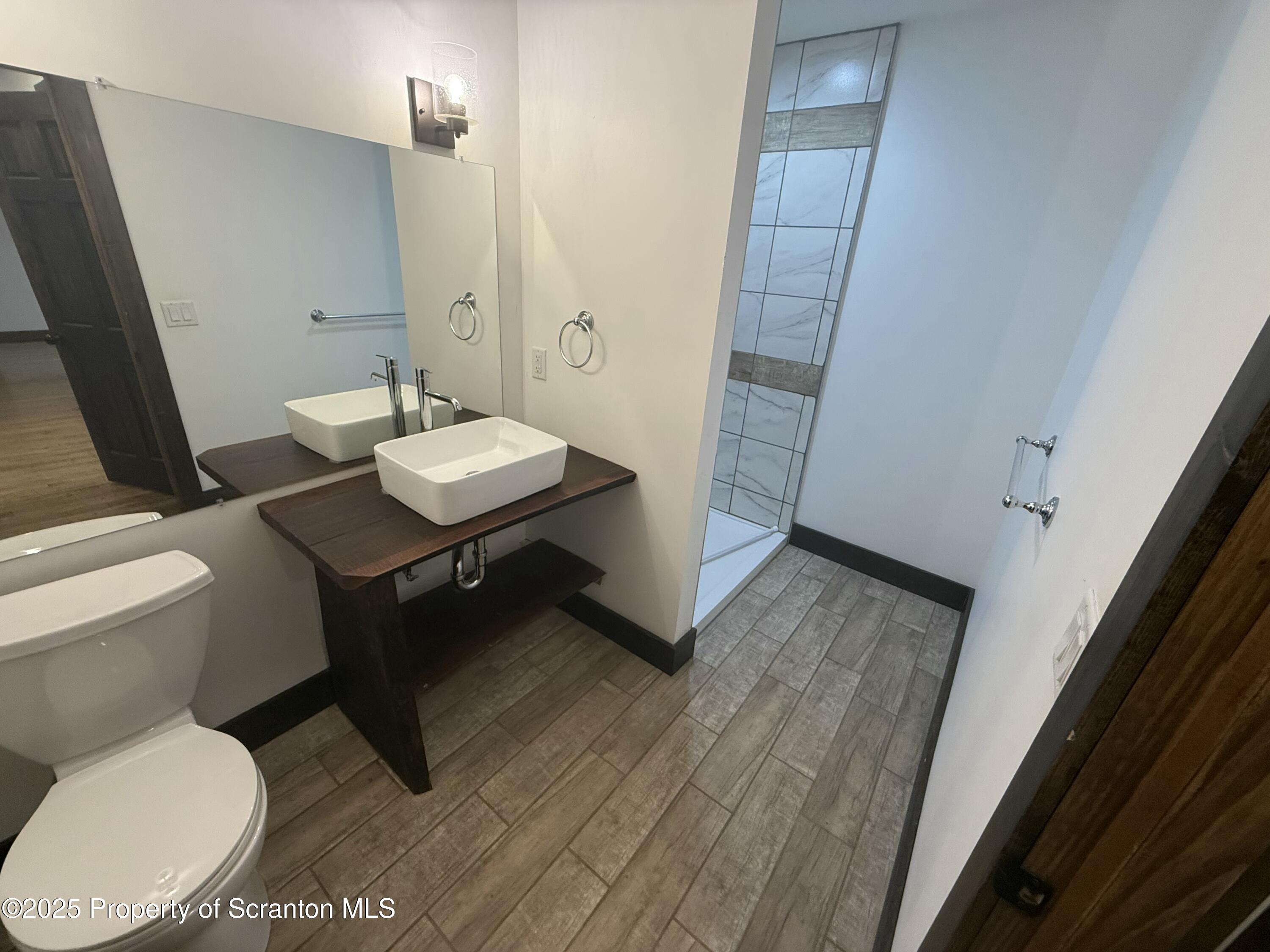 103 Park Street, Unit 1A Honesdale, PA 18431 - Photo 6 of 15 a bathroom with a toilet a sink and mirror