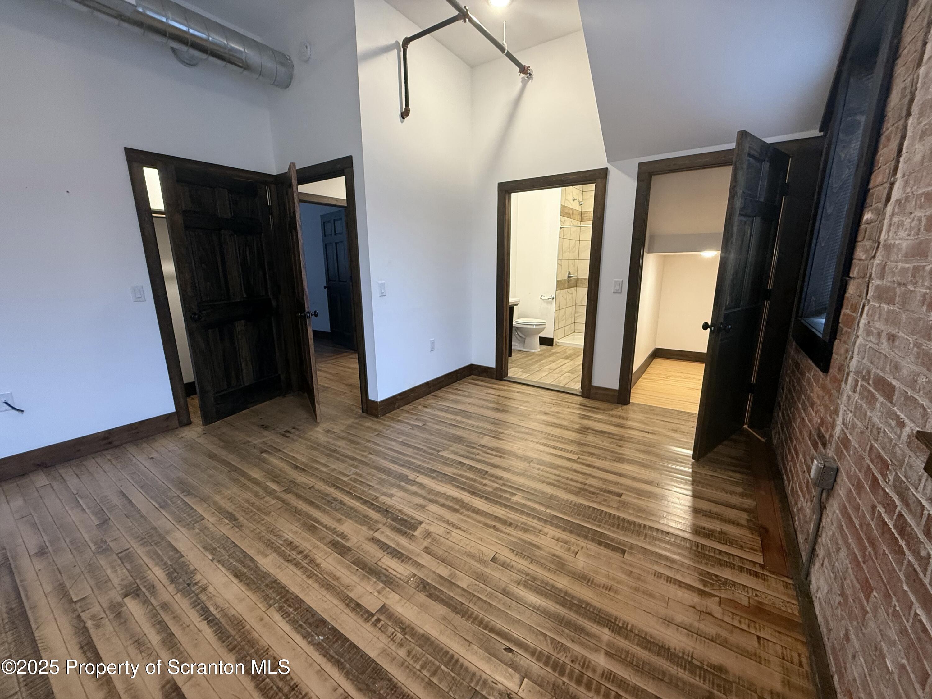 103 Park Street, Unit 1A Honesdale, PA 18431 - Photo 9 of 15 a view of hallway with stairs and wooden floor