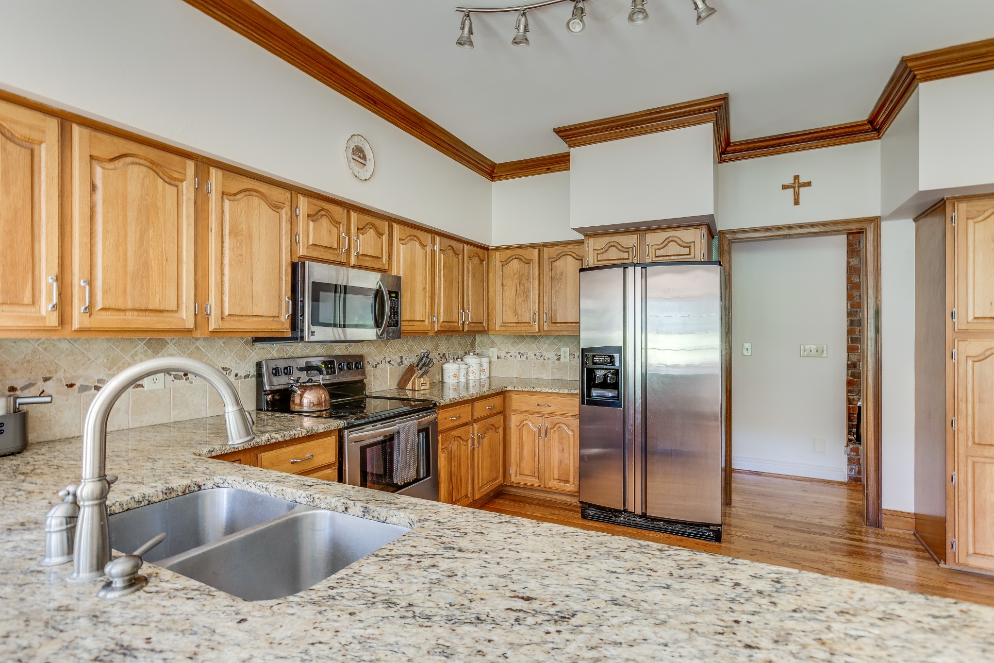1111 Temple Ridge Court Nashville, TN 37221 - Photo 19 of 46 a kitchen with stainless steel appliances granite countertop a sink refrigerator and microwave
