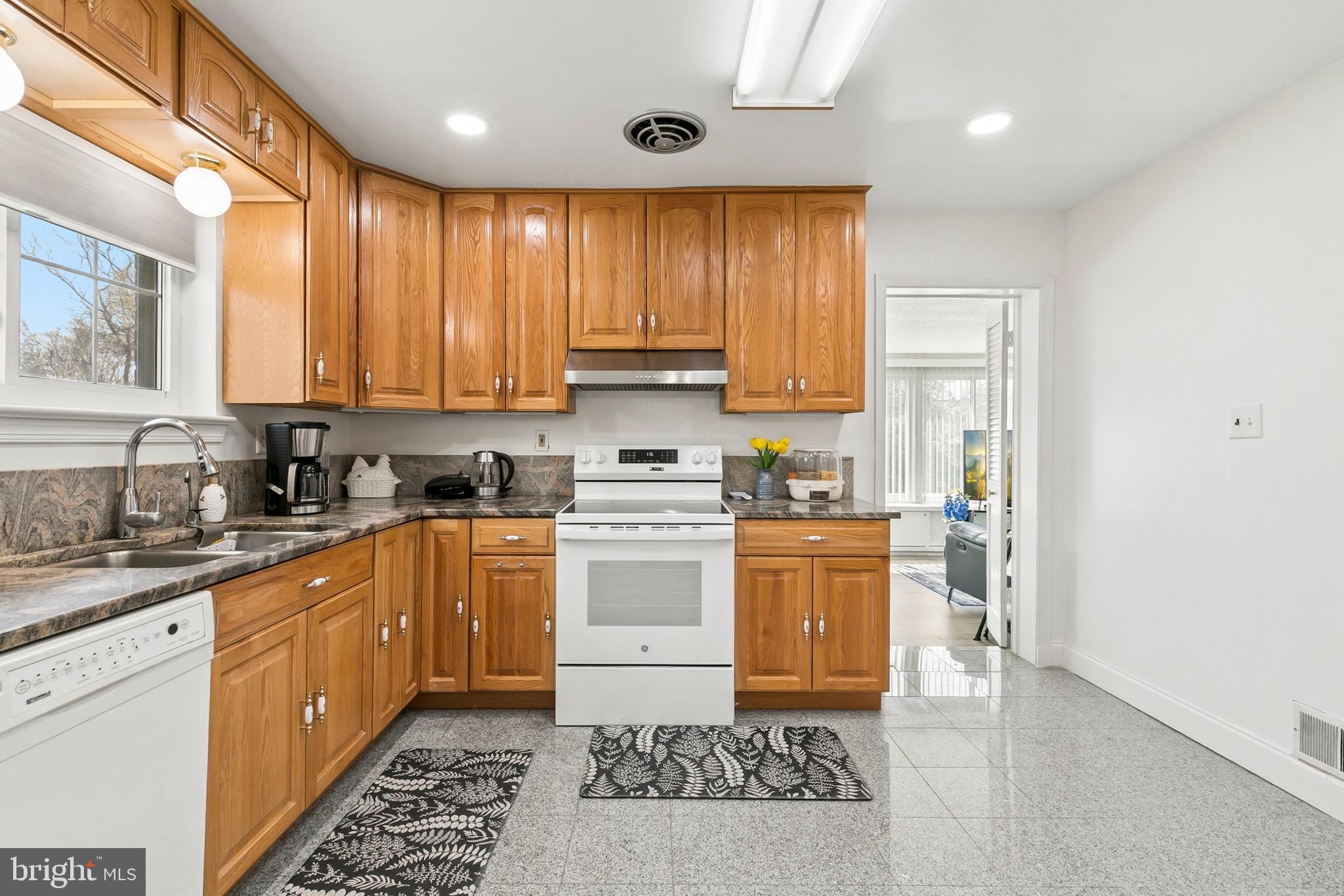 12829 Baker Drive Silver Spring, MD 20904 - Photo 15 of 59 a kitchen with a stove a sink and a refrigerator