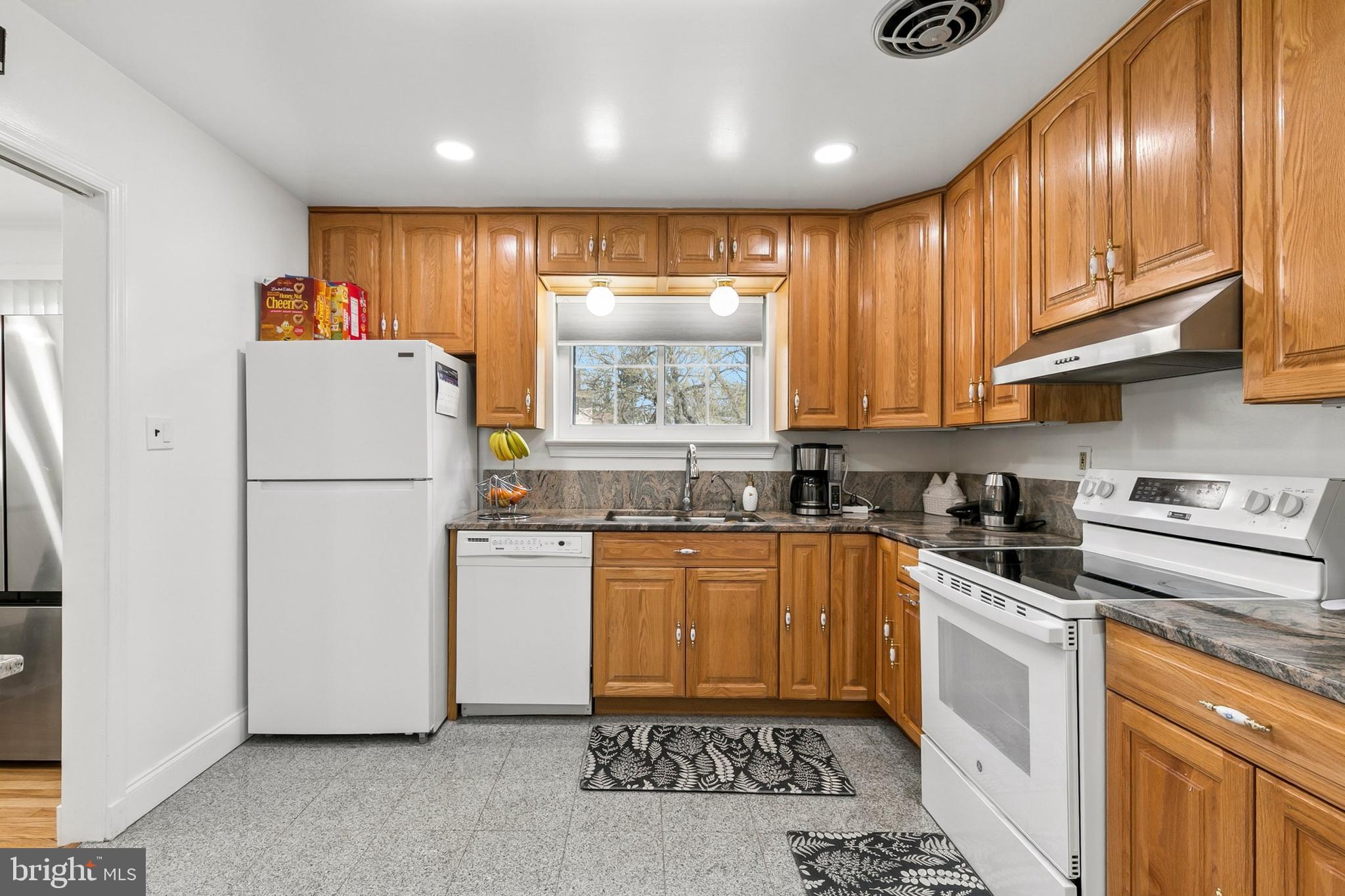 12829 Baker Drive Silver Spring, MD 20904 - Photo 16 of 59 a kitchen with granite countertop stainless steel appliances a refrigerator sink and microwave