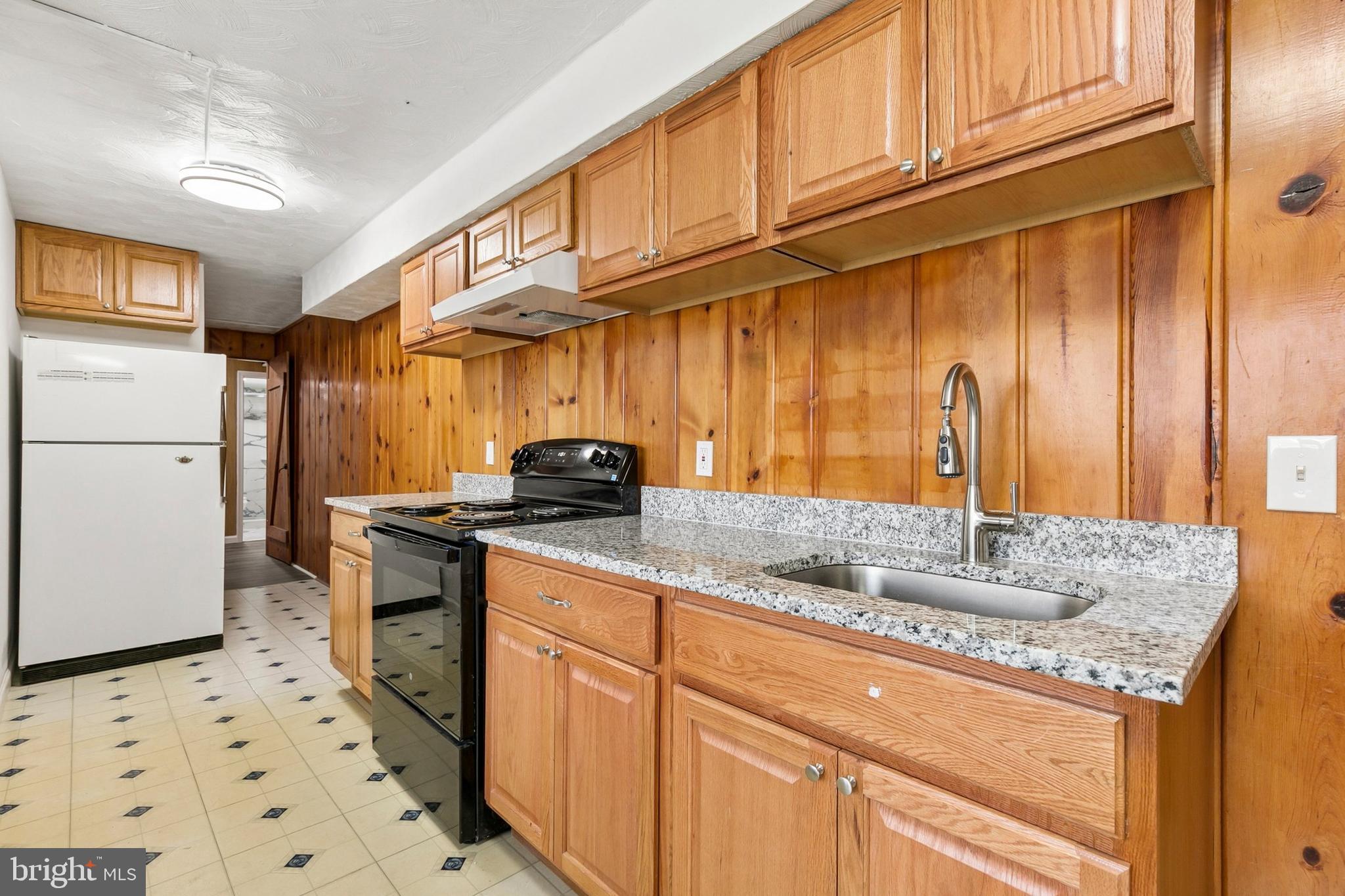 12829 Baker Drive Silver Spring, MD 20904 - Photo 25 of 59 a kitchen with stainless steel appliances granite countertop a sink stove and cabinets