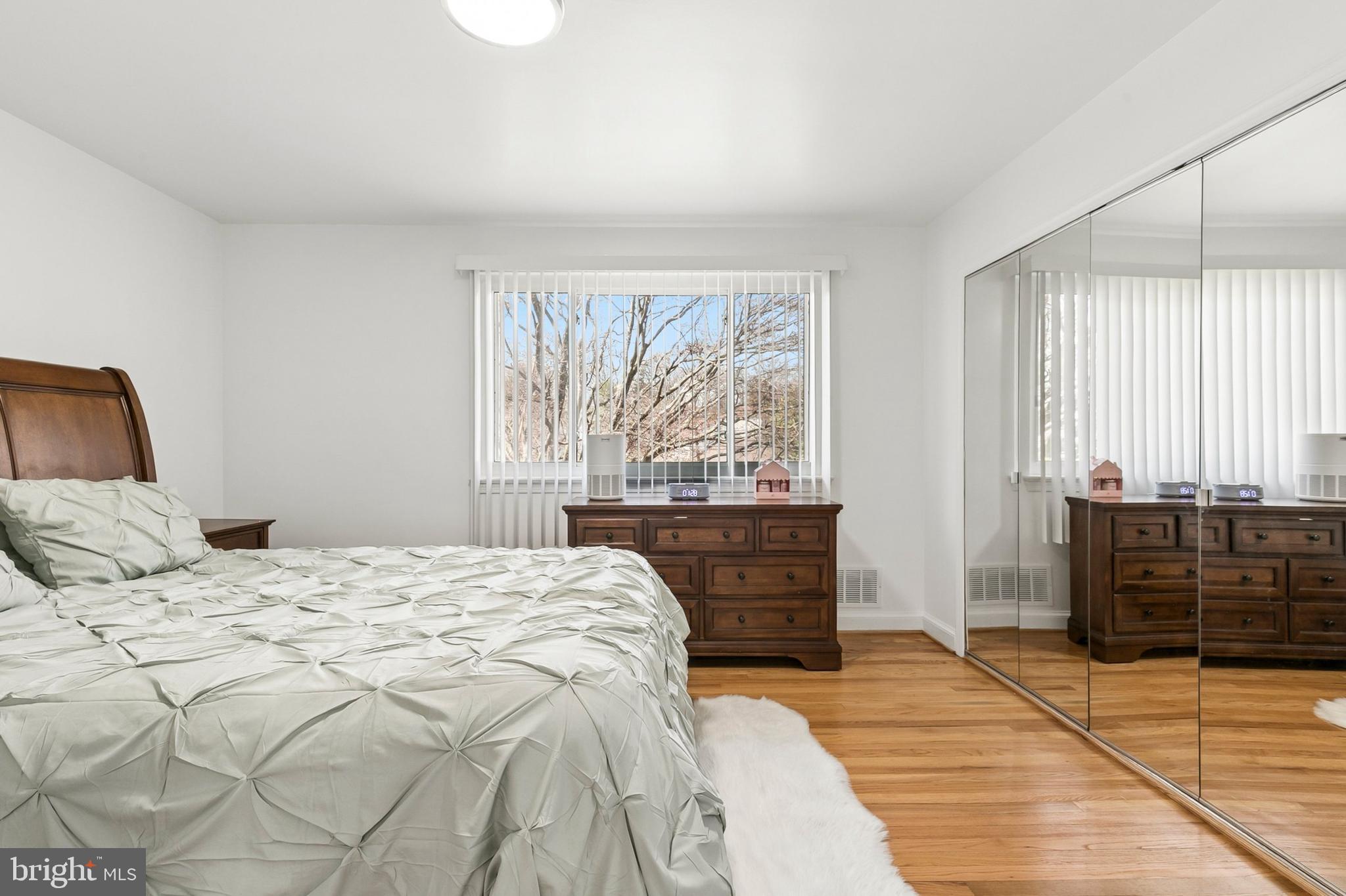 12829 Baker Drive Silver Spring, MD 20904 - Photo 30 of 59 a bedroom with a large bed and wooden floor
