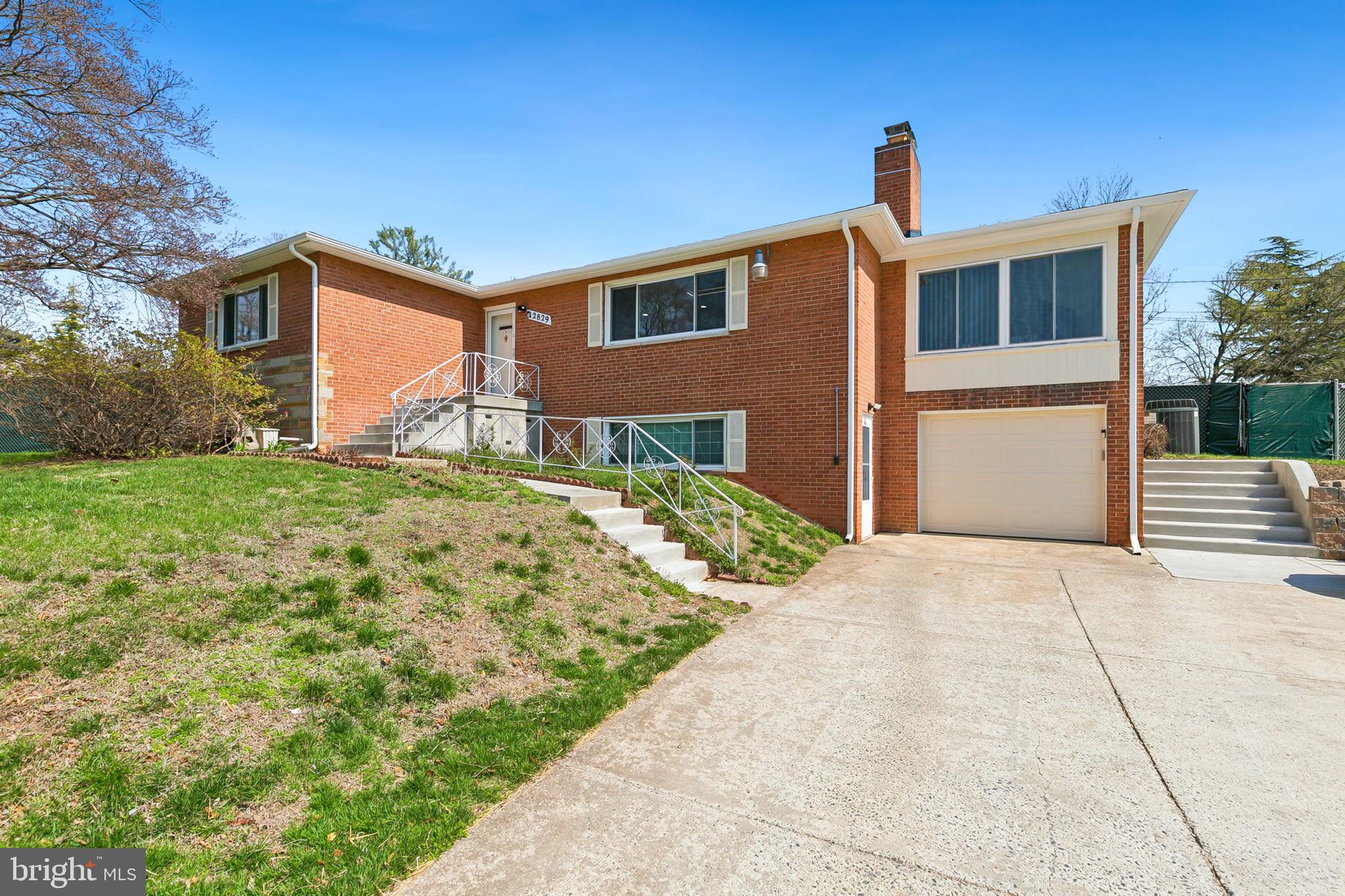 12829 Baker Drive Silver Spring, MD 20904 - Photo 3 of 59 a front view of a house with a yard