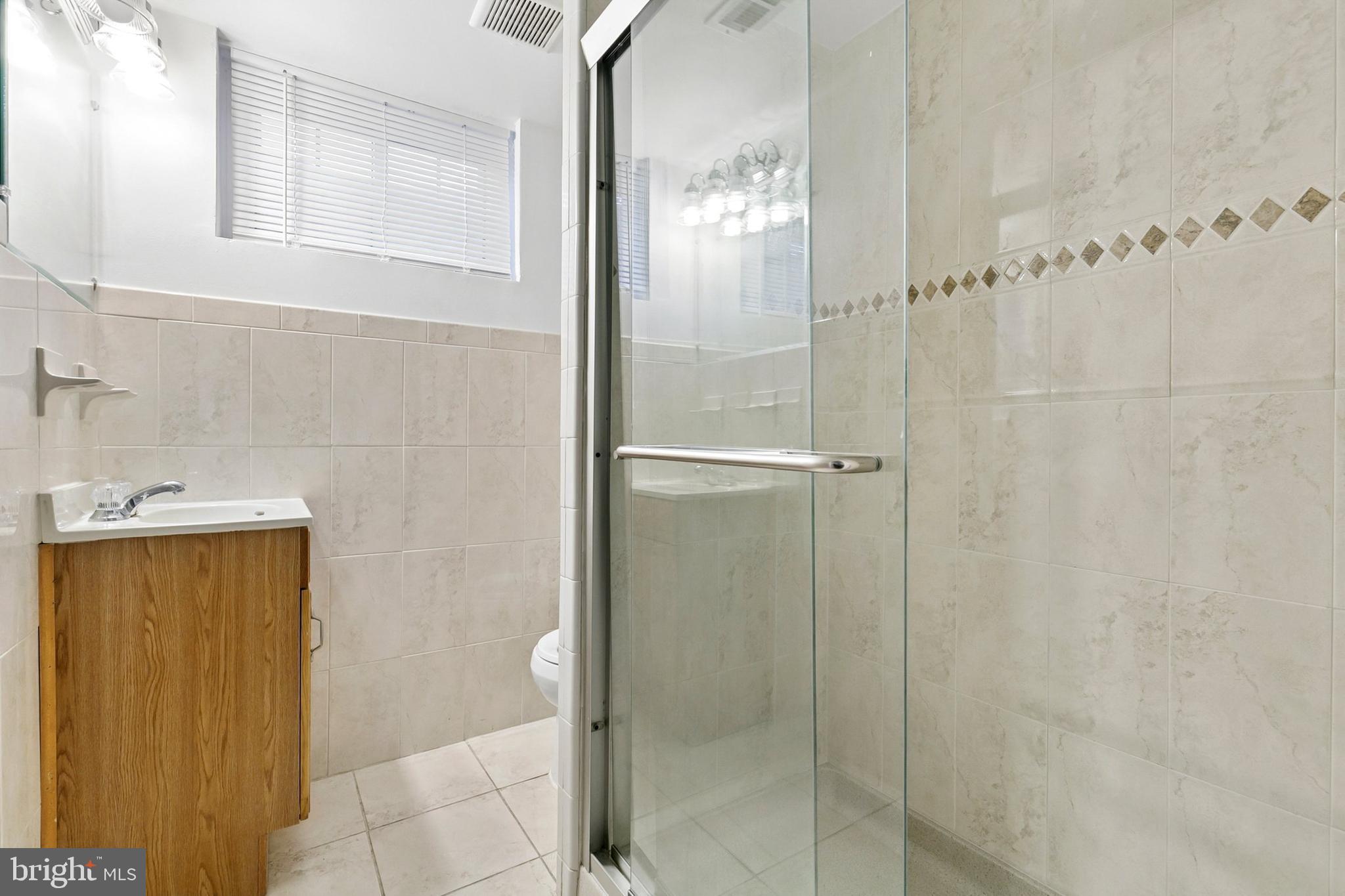 12829 Baker Drive Silver Spring, MD 20904 - Photo 37 of 59 a bathroom with a glass shower door