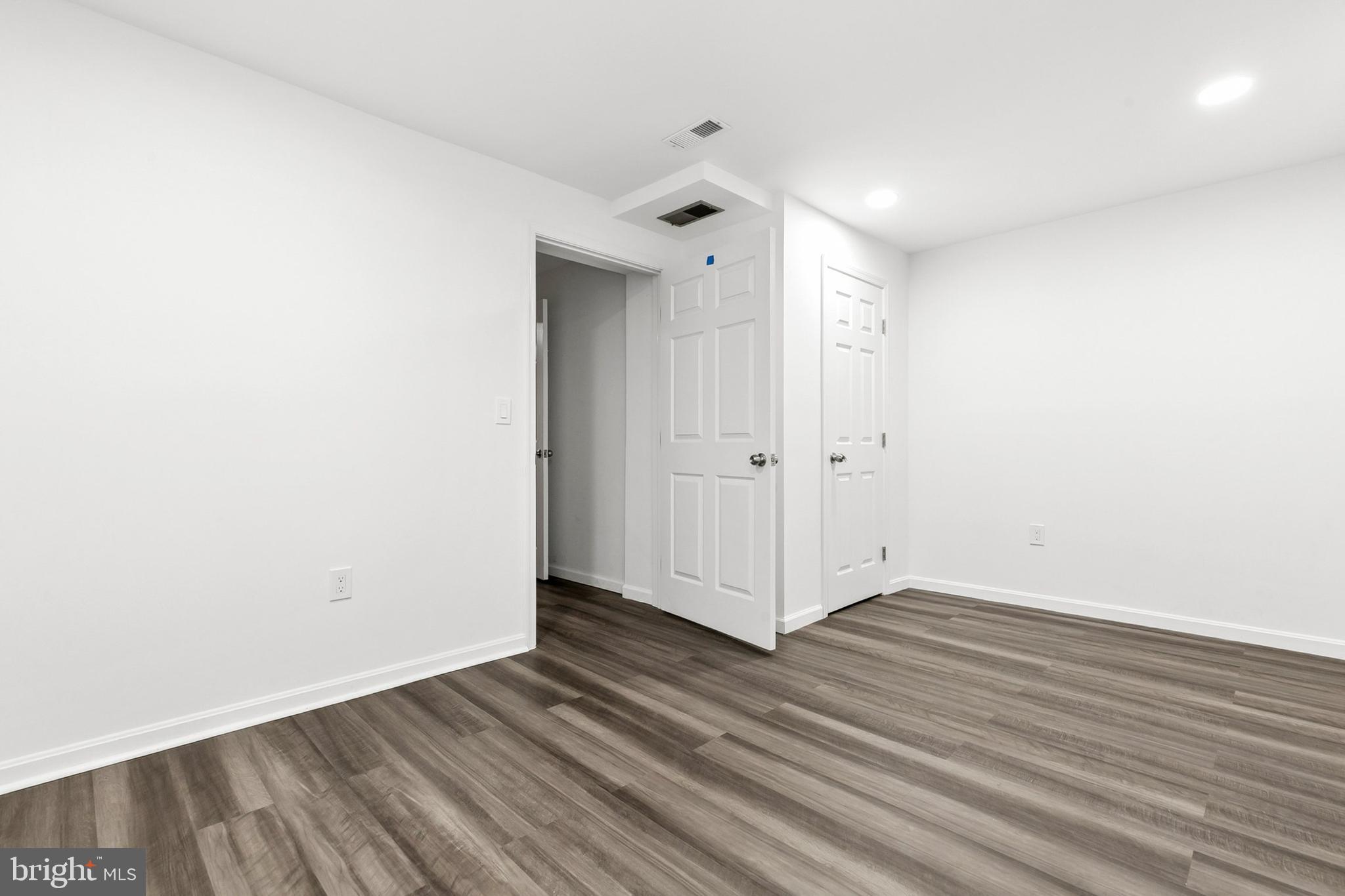 12829 Baker Drive Silver Spring, MD 20904 - Photo 41 of 59 a view of an empty room with wooden floor