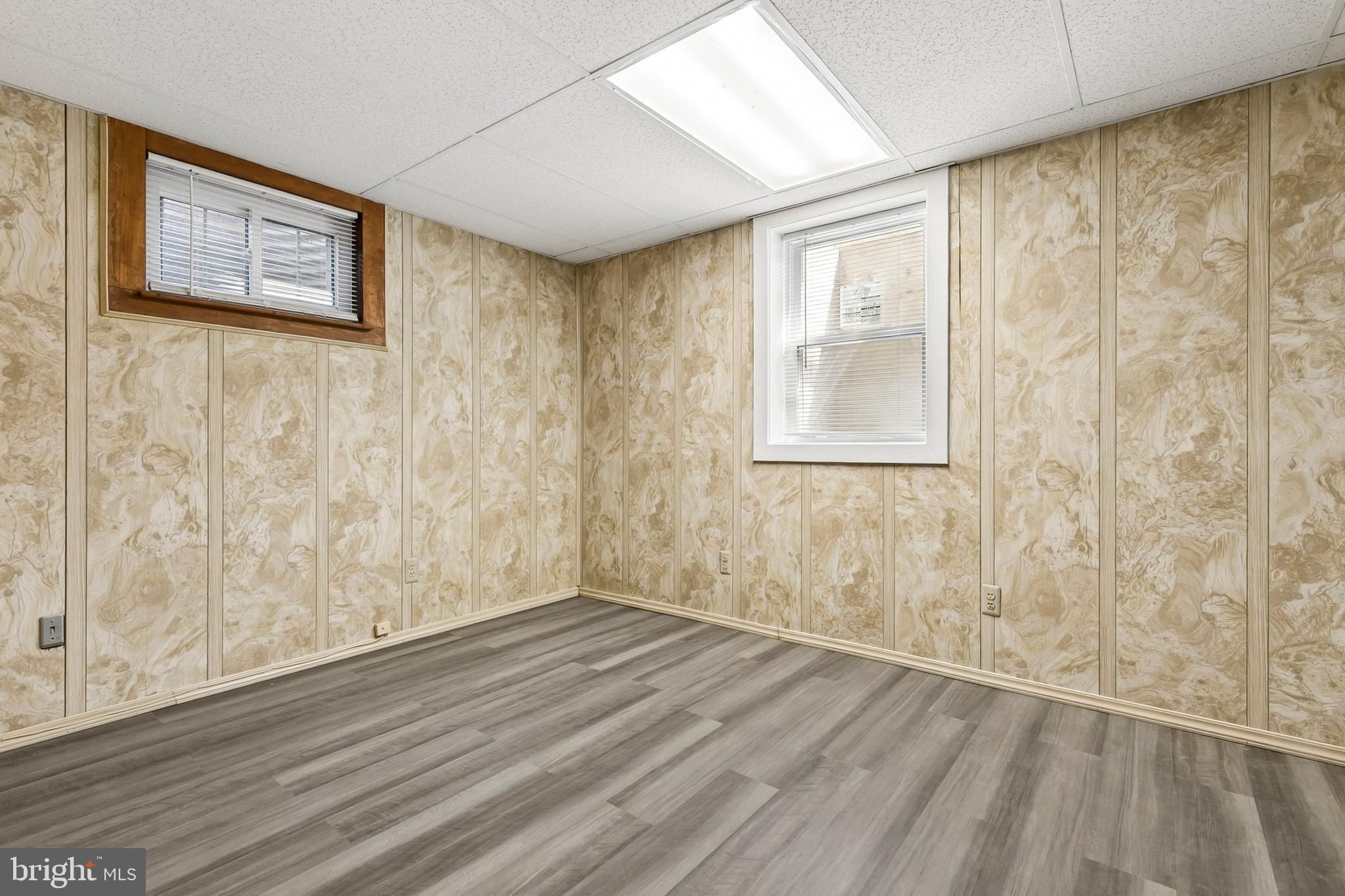 12829 Baker Drive Silver Spring, MD 20904 - Photo 42 of 59 a view of an empty room with wooden floor and a window