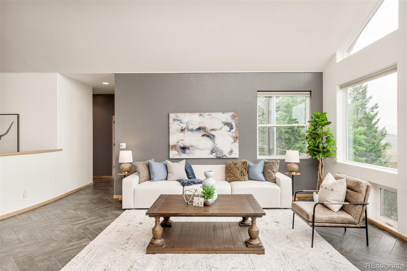 1453 Santa Fe Mountain Road Evergreen, CO 80439 - Photo 14 of 50 a living room with furniture and a large window