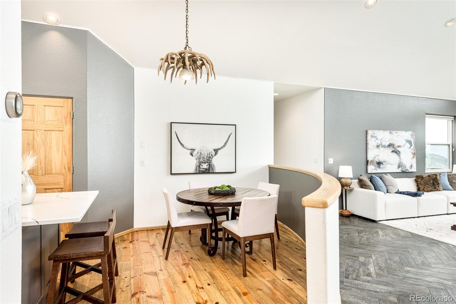 1453 Santa Fe Mountain Road Evergreen, CO 80439 - Photo 16 of 50 a view of a dining room with furniture and wooden floor