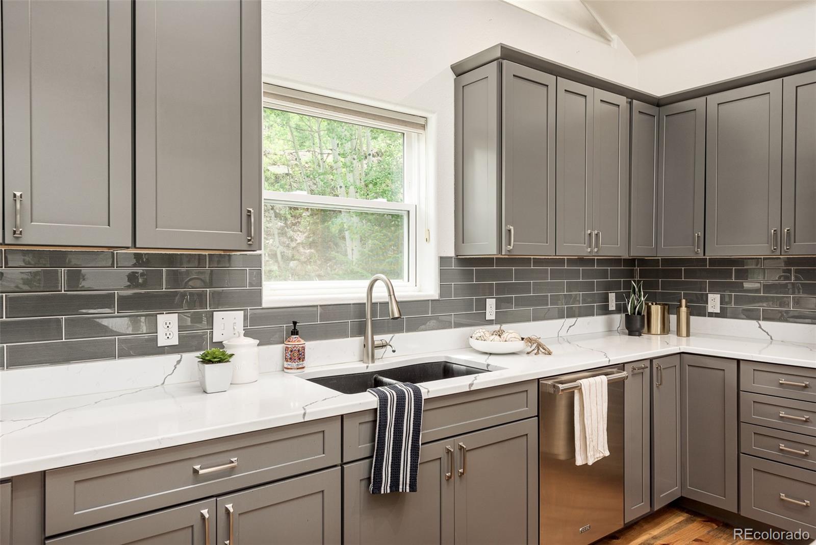 1453 Santa Fe Mountain Road Evergreen, CO 80439 - Photo 19 of 50 a kitchen with a sink cabinets and window