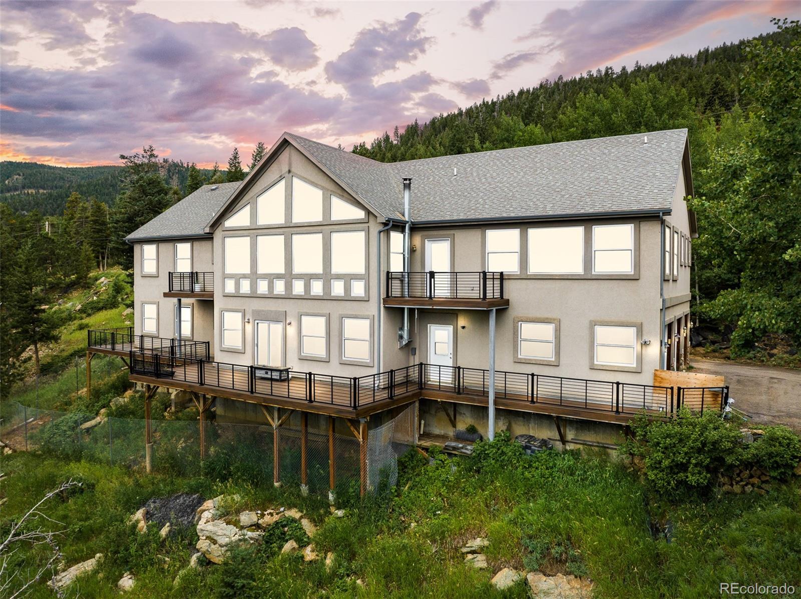 1453 Santa Fe Mountain Road Evergreen, CO 80439 - Photo 2 of 50 a view of a house with a yard