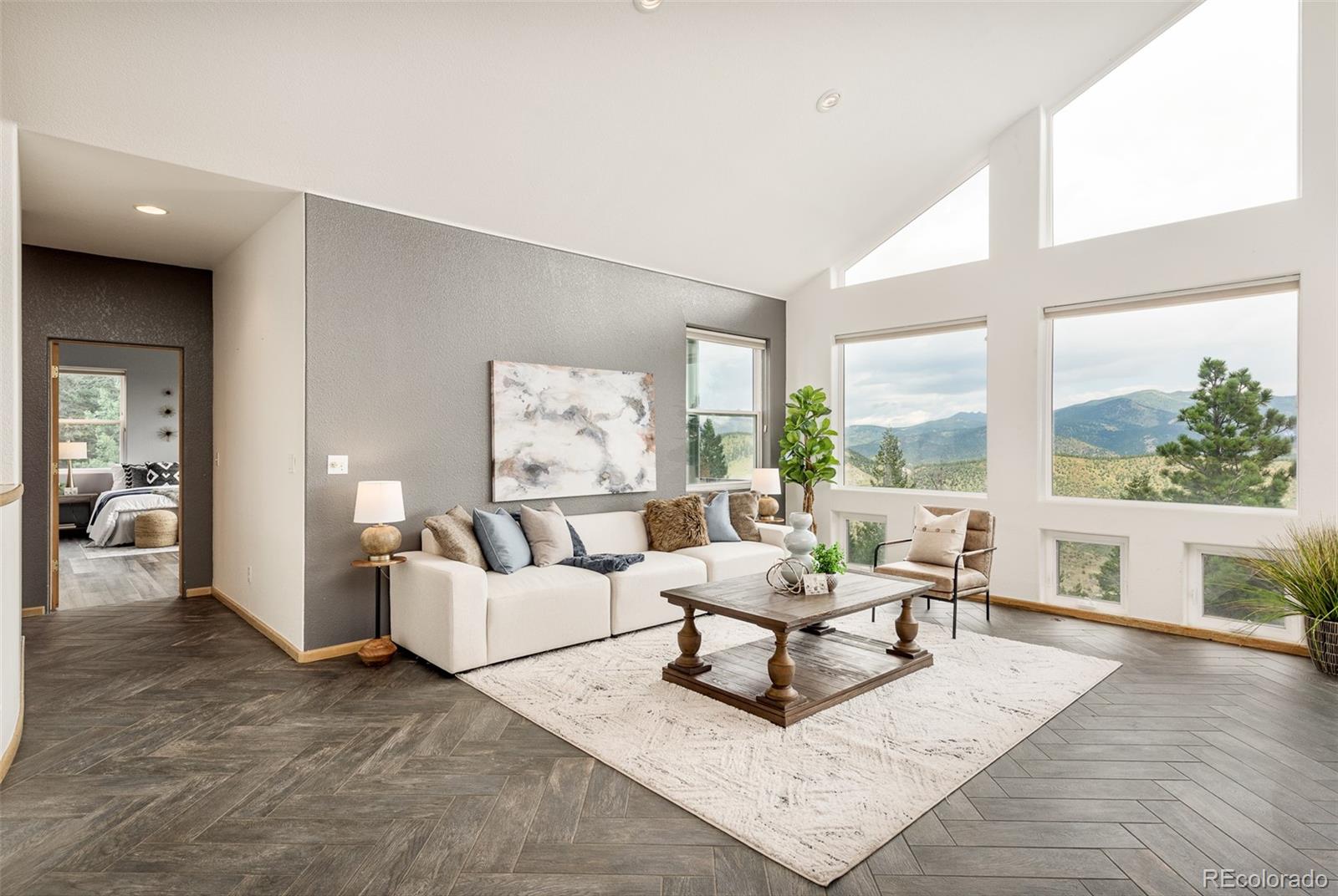1453 Santa Fe Mountain Road Evergreen, CO 80439 - Photo 21 of 50 a living room with furniture and a large window