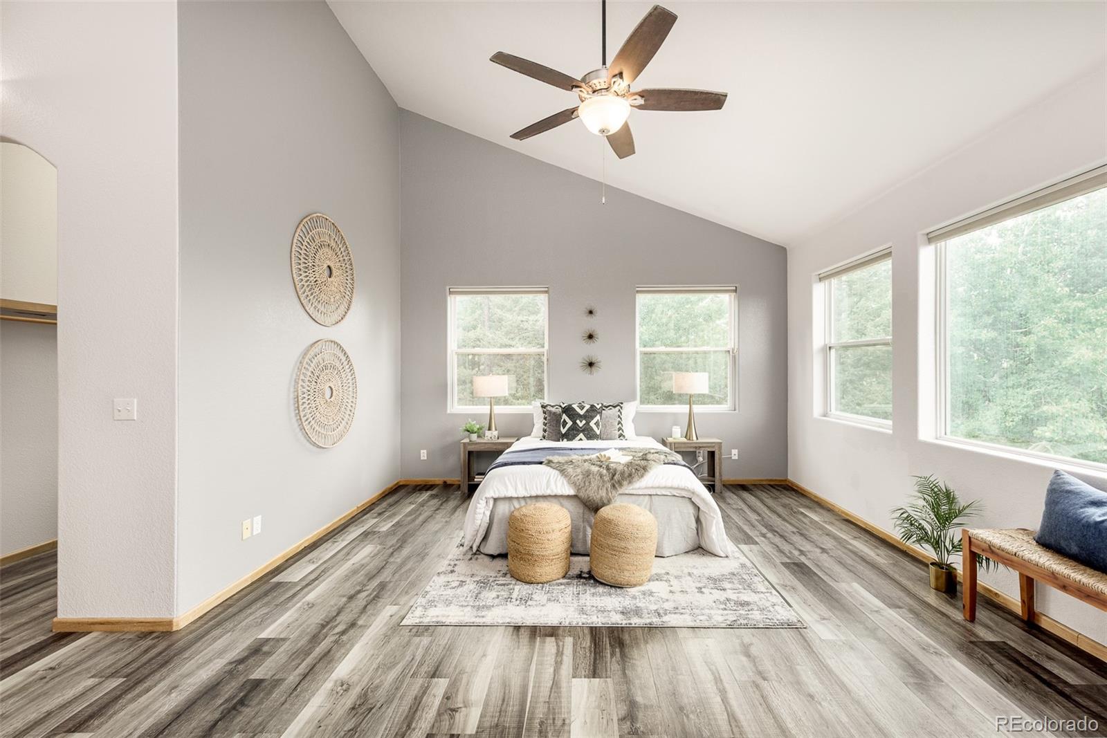 1453 Santa Fe Mountain Road Evergreen, CO 80439 - Photo 22 of 50 a bedroom with a bed and wooden floor