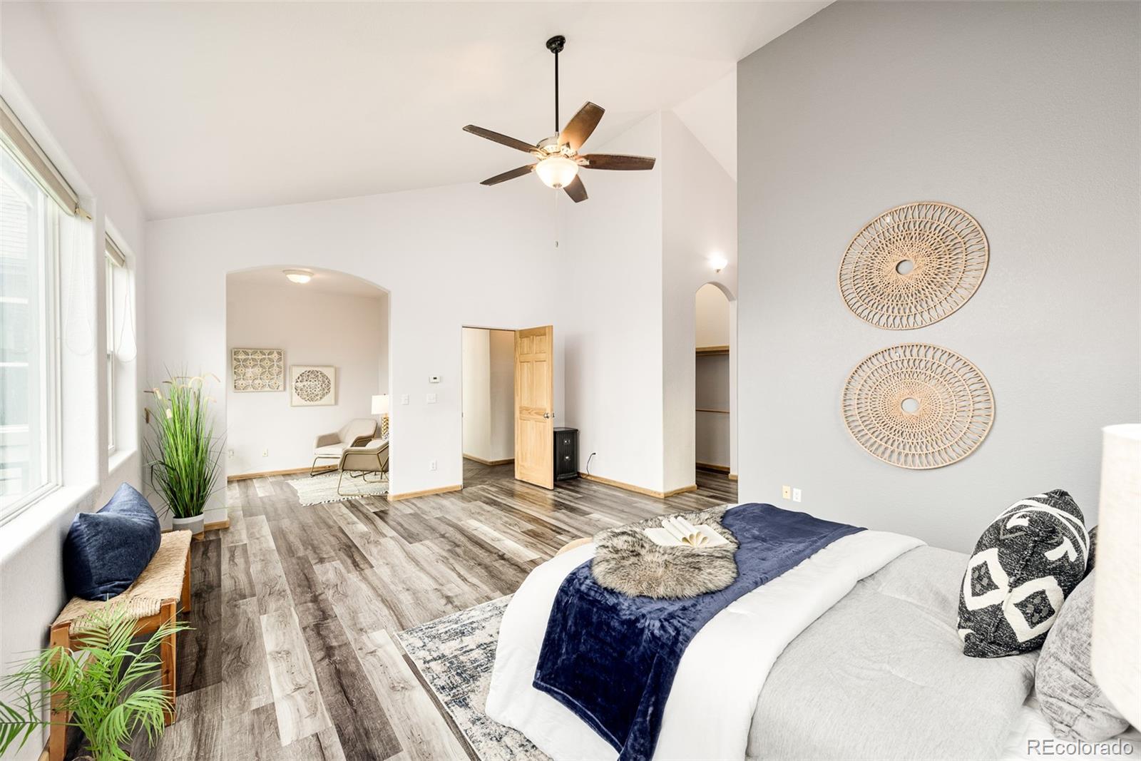 1453 Santa Fe Mountain Road Evergreen, CO 80439 - Photo 25 of 50 a bedroom with a bed and chandelier