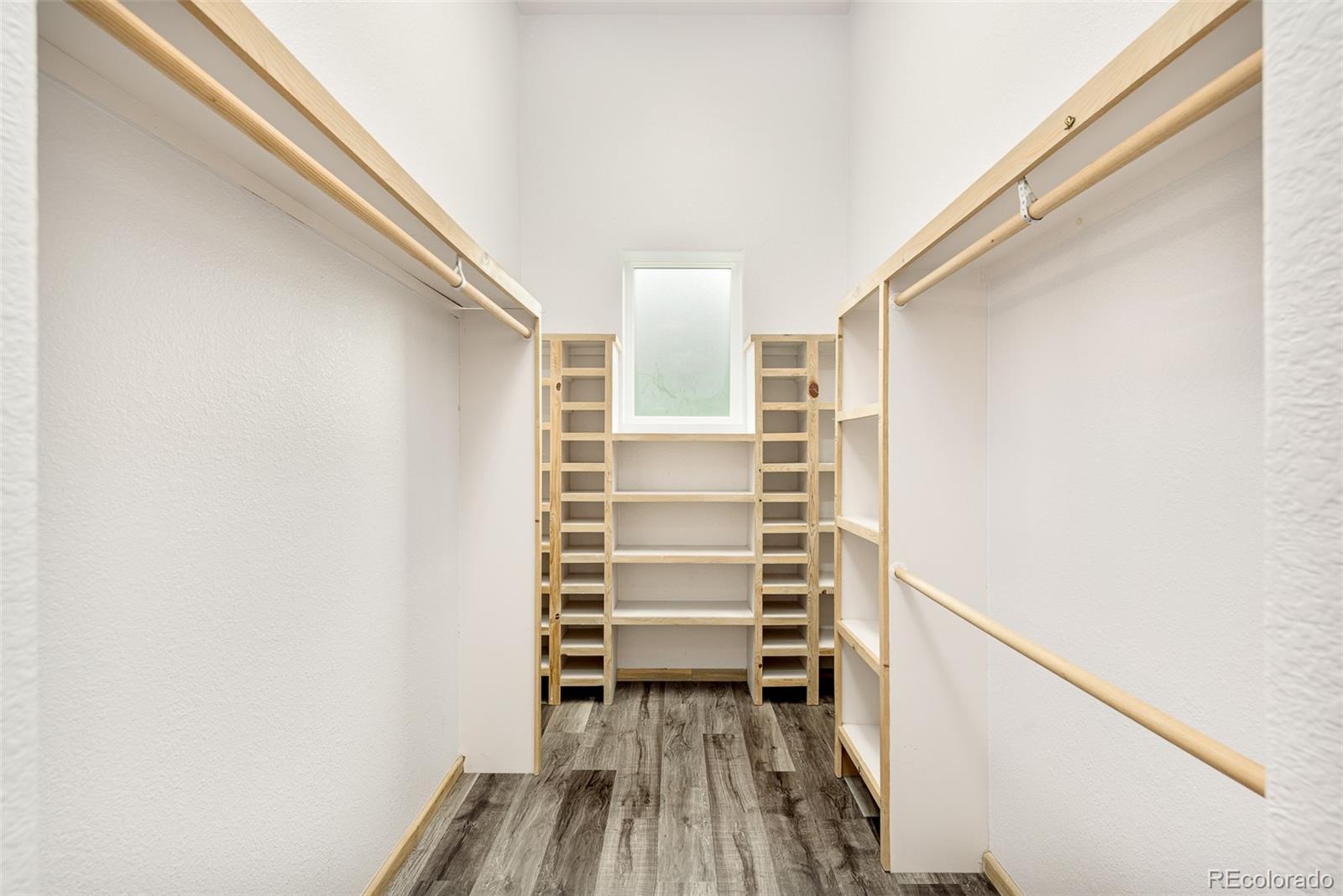1453 Santa Fe Mountain Road Evergreen, CO 80439 - Photo 30 of 50 a view of closet with wooden floor and stairs