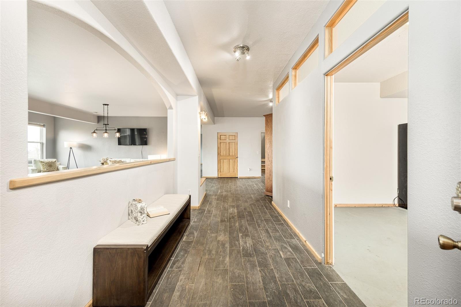 1453 Santa Fe Mountain Road Evergreen, CO 80439 - Photo 34 of 50 a view of a hallway with wooden floor and staircase