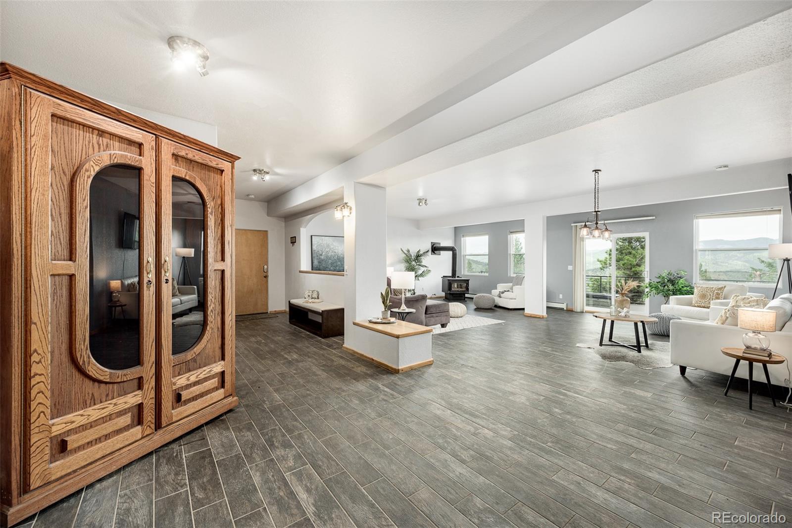 1453 Santa Fe Mountain Road Evergreen, CO 80439 - Photo 35 of 50 a living room with furniture and wooden floor