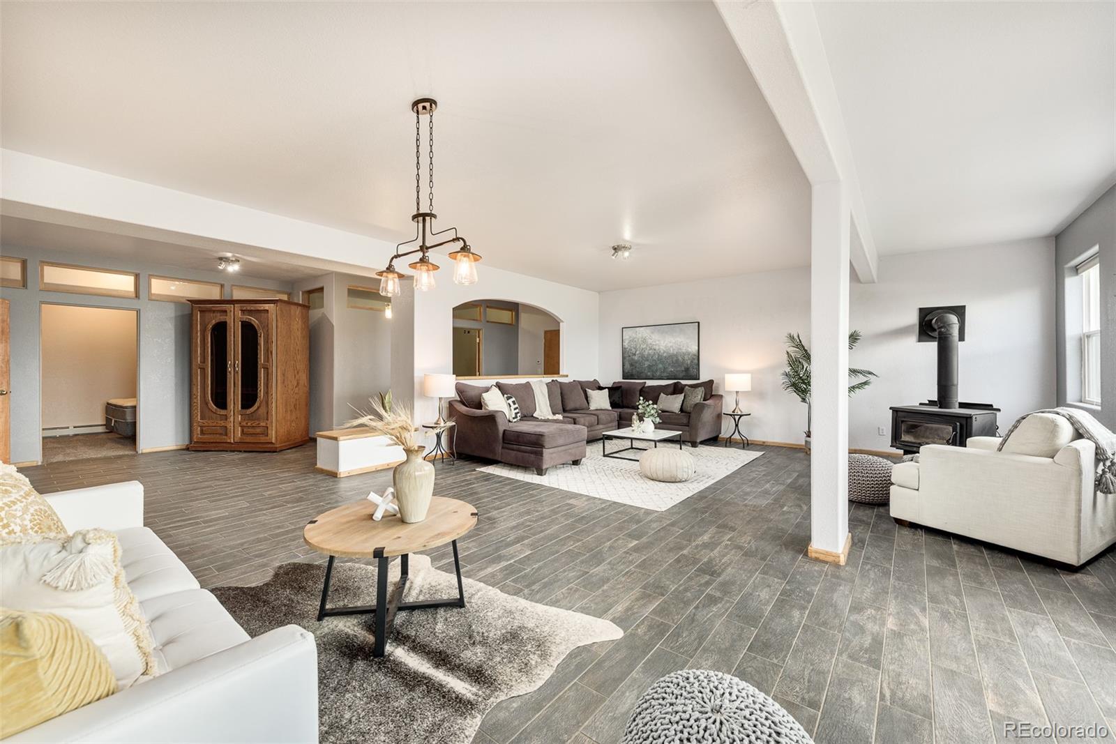 1453 Santa Fe Mountain Road Evergreen, CO 80439 - Photo 36 of 50 a living room with furniture chandelier and view of kitchen