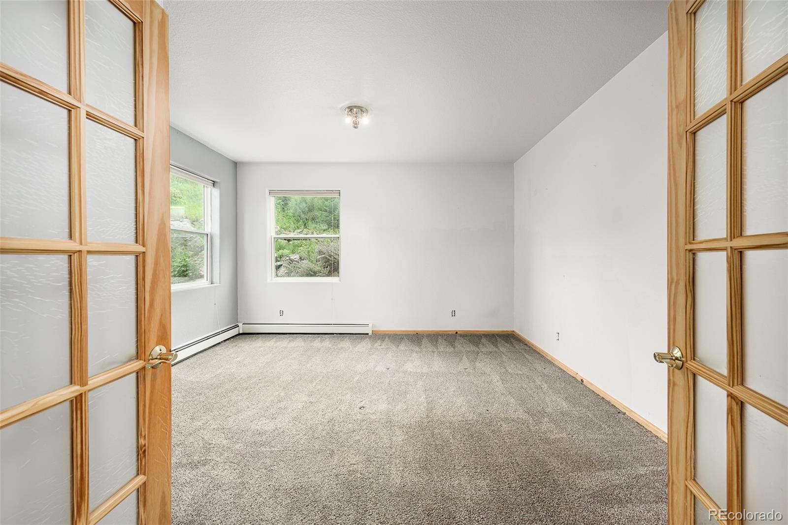 1453 Santa Fe Mountain Road Evergreen, CO 80439 - Photo 39 of 50 a view of an empty room with a window