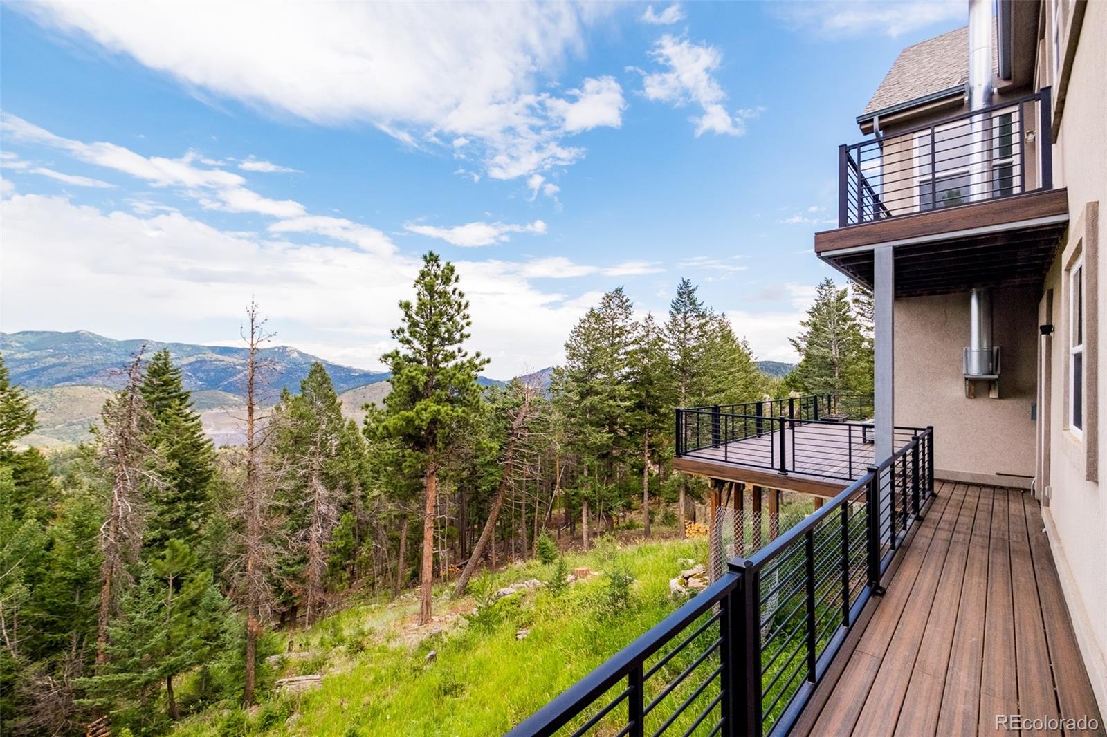 1453 Santa Fe Mountain Road Evergreen, CO 80439 - Photo 40 of 50 a view of a house with swimming pool and sitting area