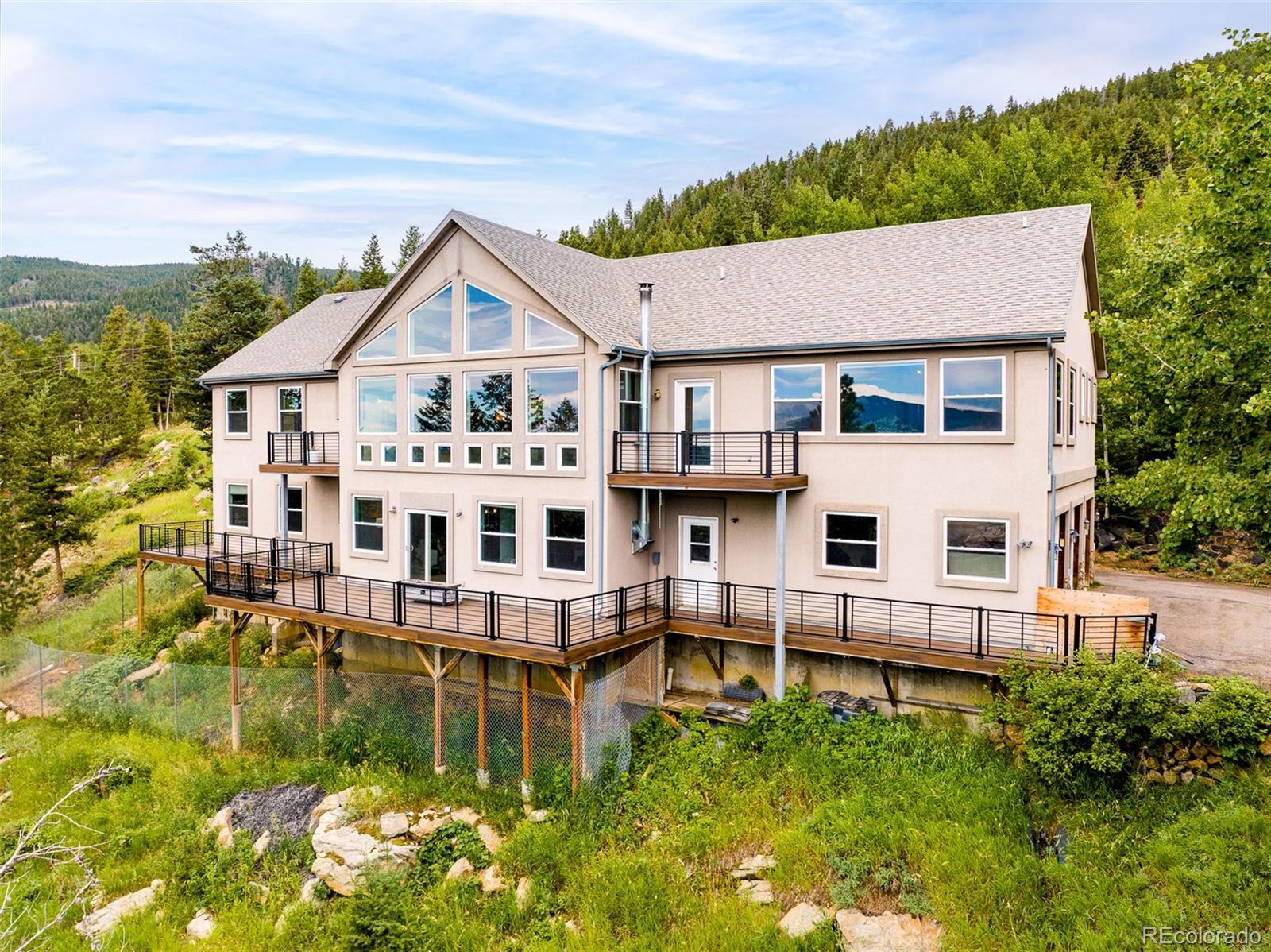 1453 Santa Fe Mountain Road Evergreen, CO 80439 - Photo 4 of 50 a aerial view of a house with swimming pool and a yard