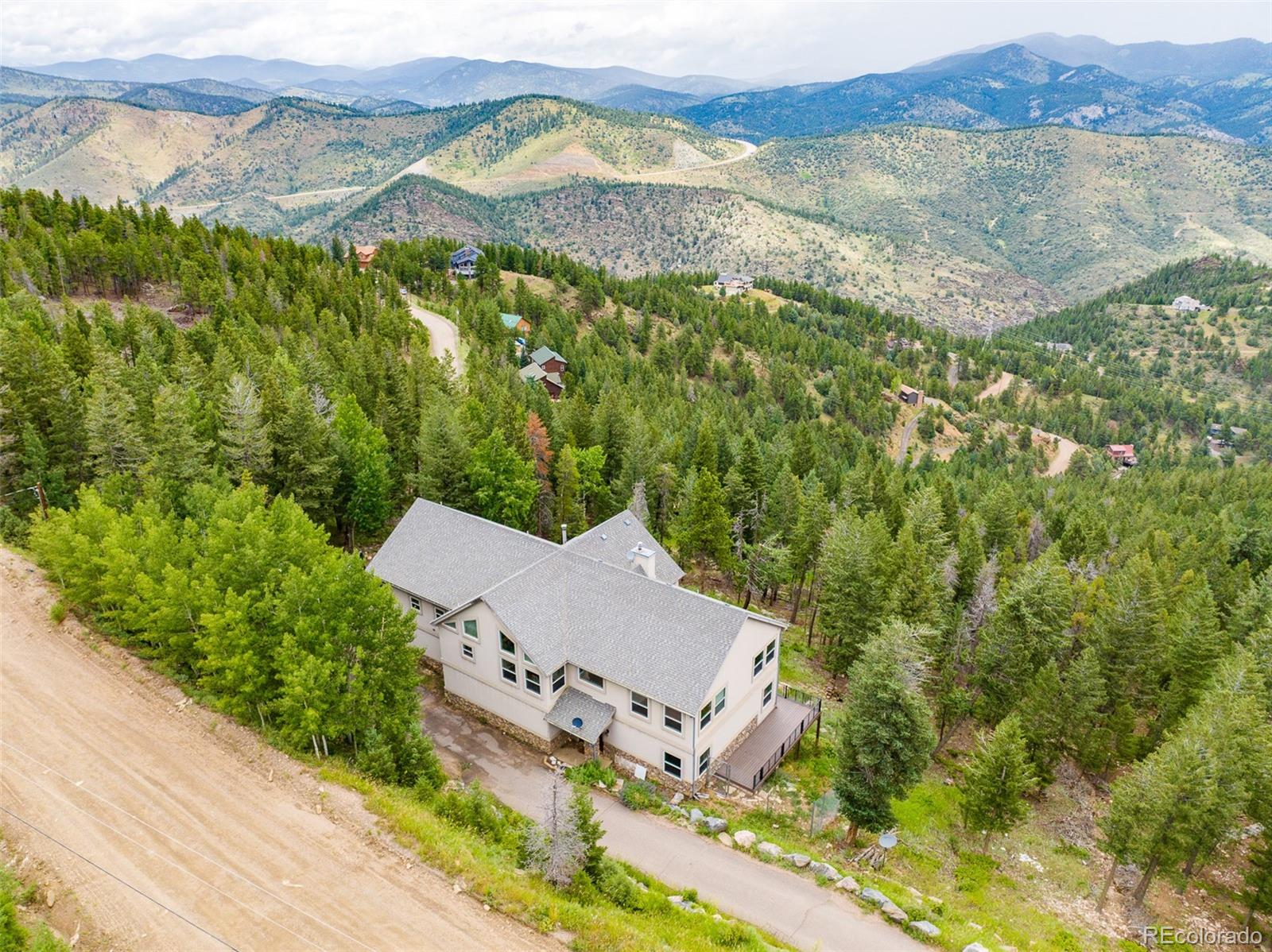 1453 Santa Fe Mountain Road Evergreen, CO 80439 - Photo 47 of 50 an aerial view of residential house with pool and yard
