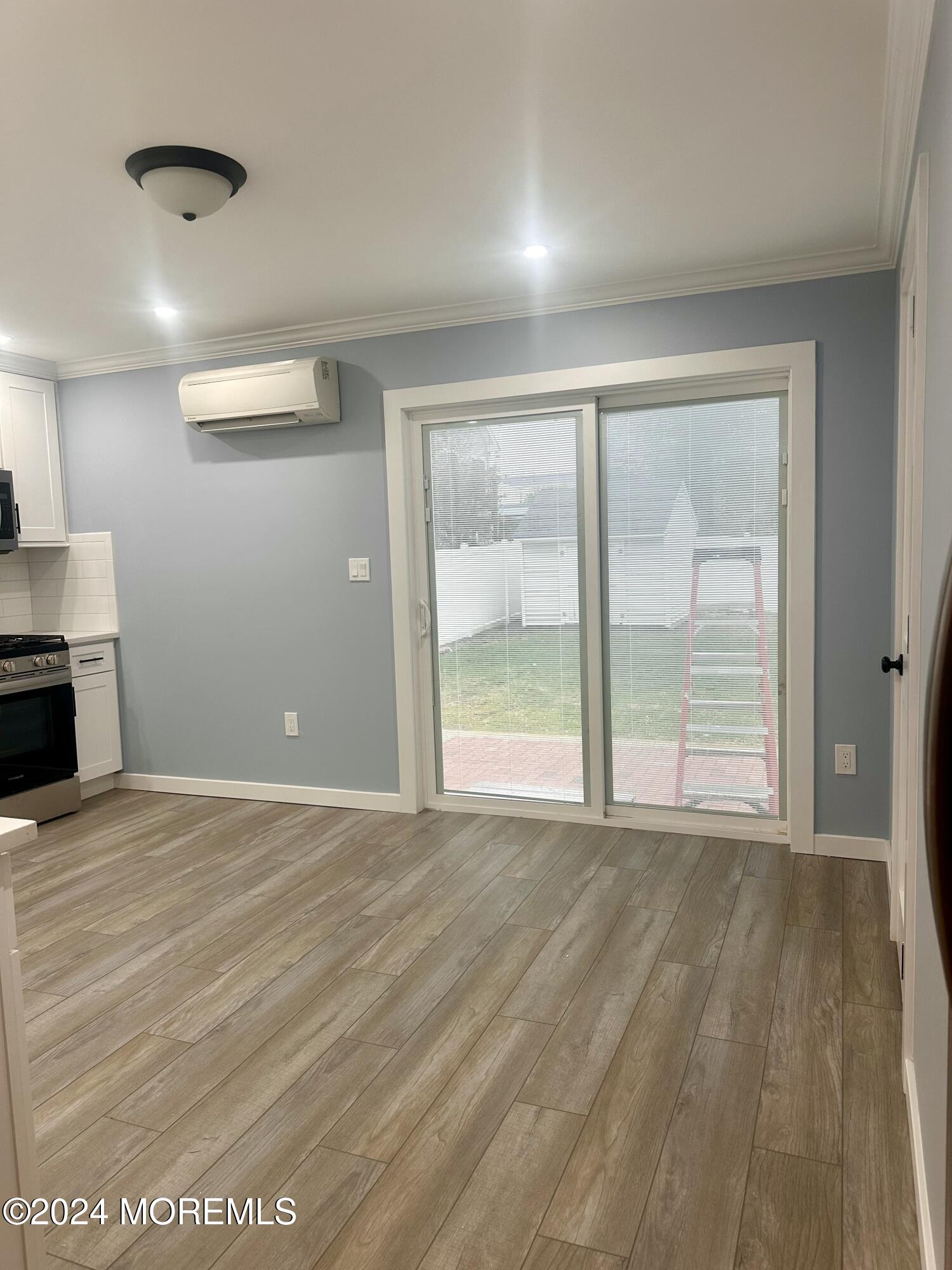 73 Church Street Manasquan, NJ 08736 - Photo 11 of 27 a view of an empty room with a window and wooden floor