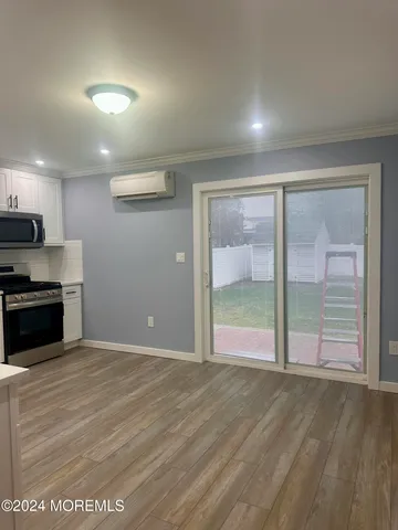 a kitchen with stainless steel appliances granite countertop a sink a stove and cabinets